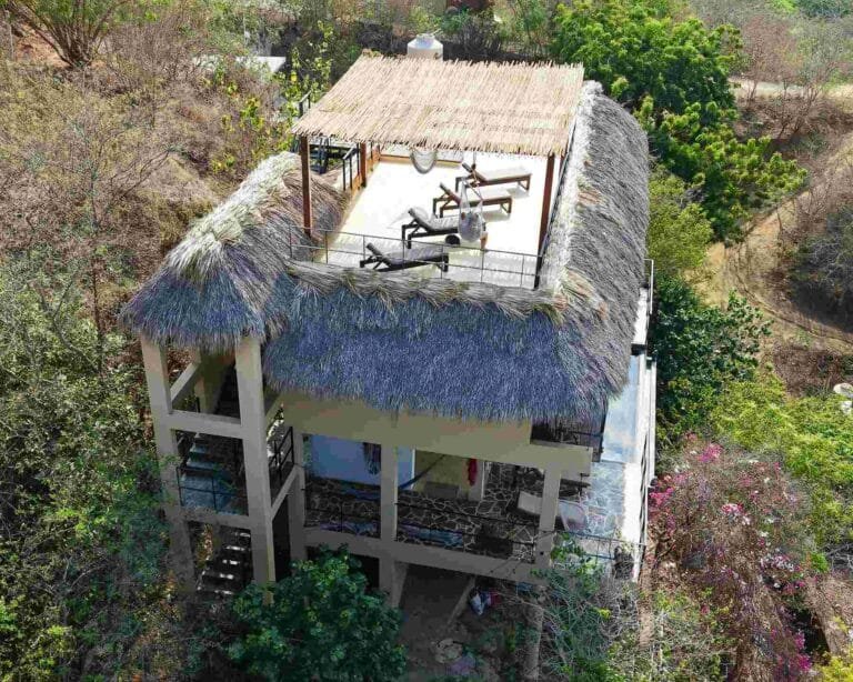 Vista aérea de la azotea con pérgola de madera tropical y camastros