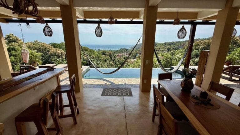 Dining area with a wooden bar, pool and hammock overlooking the sea at Casa La Vista, Mazunte