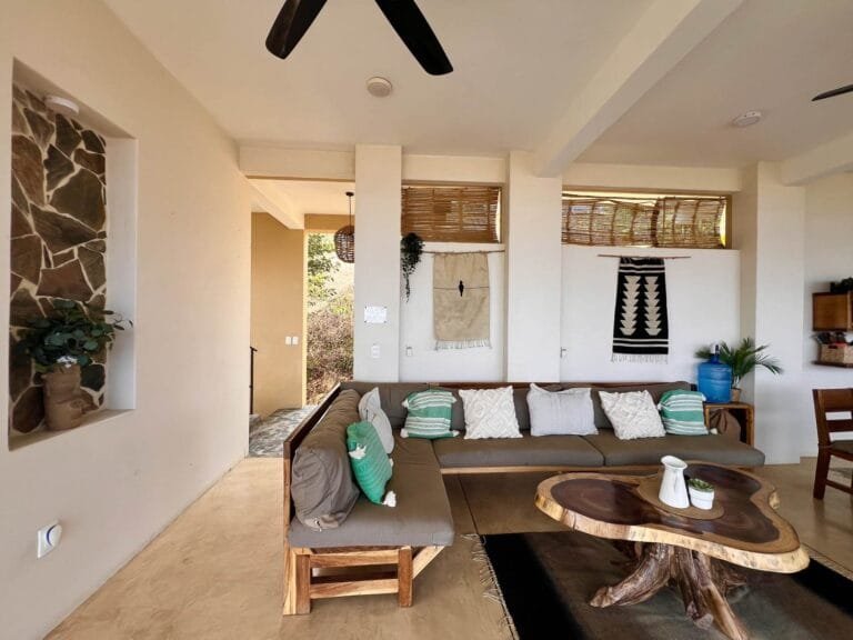 Living room with a corner sofa and a natural stone niche at Casa La Vista, Mazunte